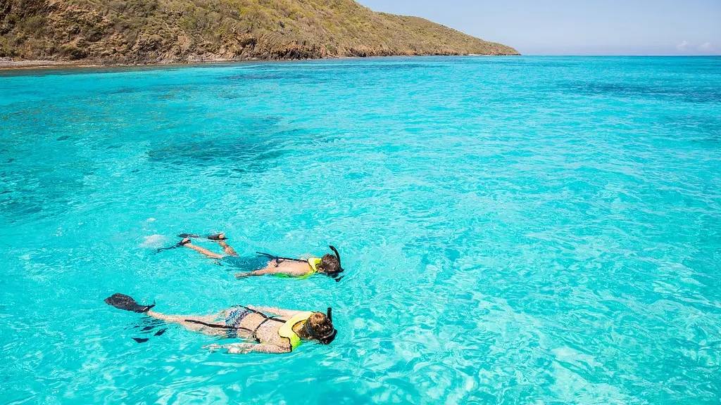 Two snorkelers in clear turquoise water